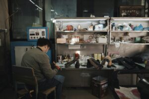 Shoe factory workbench (placeholder, Unsplash / EvoMao)