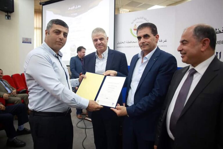 NABOLY receiving a certificate of recognition at a Hebron industry event