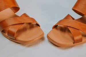 A pair of brown leather sandals photographed from above
